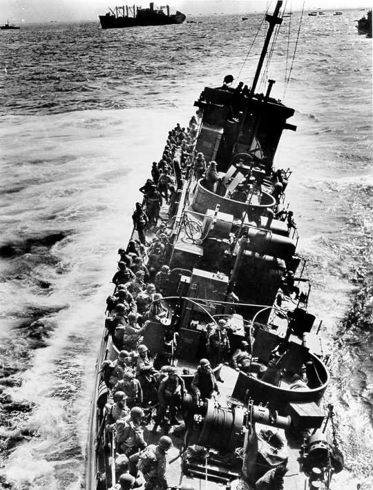 The Coast Guard LCI(L)-85, battered by enemy fire after approaching Omaha Beach, prepares to evacuate the troops she was transporting to an awaiting transport. The "85" sank shortly after this photograph was taken. The LCI(L)-85 was one of four Coast Guard LCI's that were destroyed on D-Day. The Coast Guard LCI(L)-85, battered by enemy fire after approaching Omaha Beach, prepares to evacuate the troops she was transporting to an awaiting transport. The "85" sank shortly after this photograph was taken. The LCI(L)-85 was one of four Coast Guard LCI's that were destroyed on D-Day.